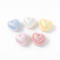 Puffy Heart Clicker fidget toys in blue, white, yellow, light pink and rose pink, white background